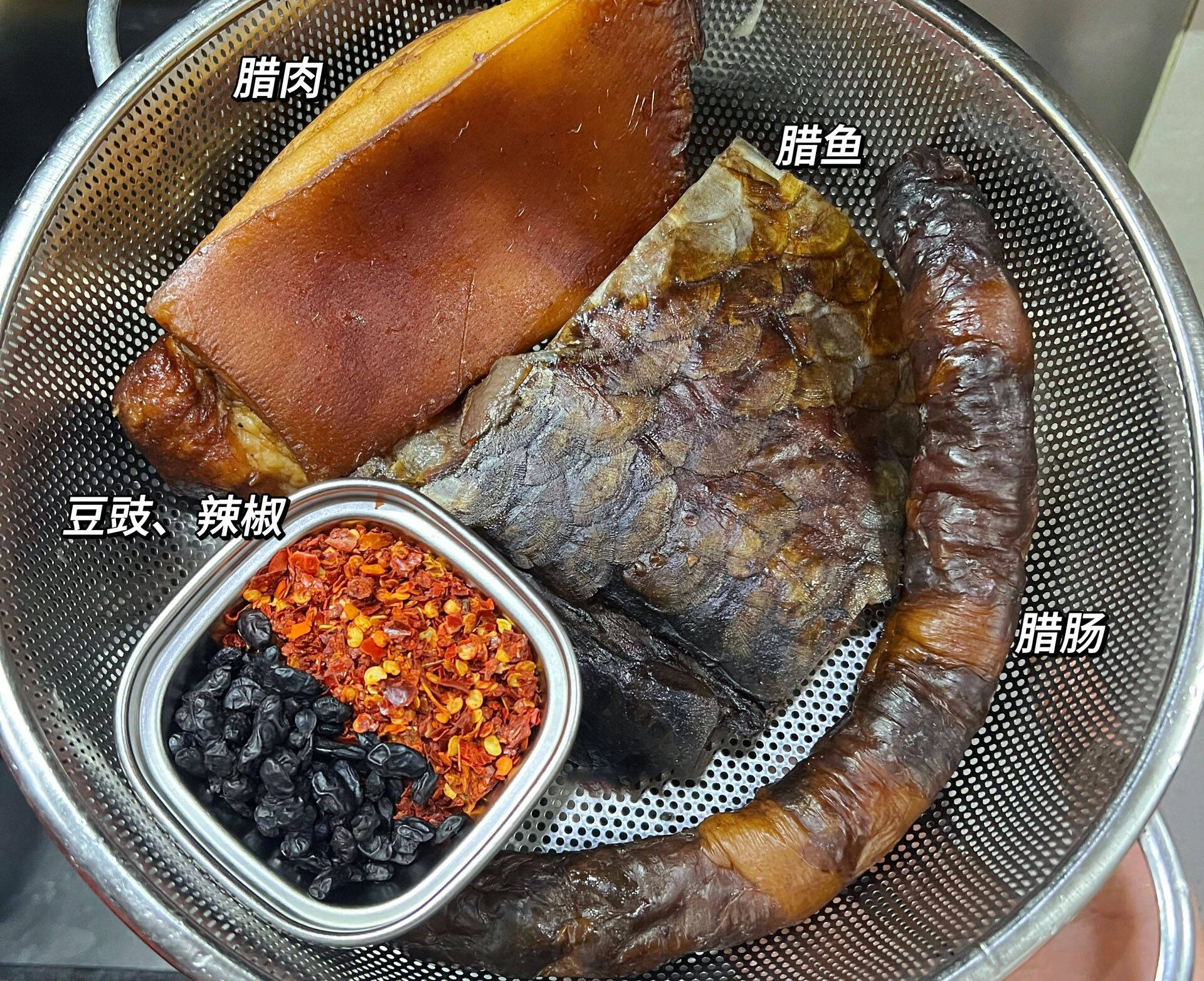 它的食材并不复杂:腊肉,腊肠,腊鱼为主角,辅以干辣椒,豆豉,蒜,葱等
