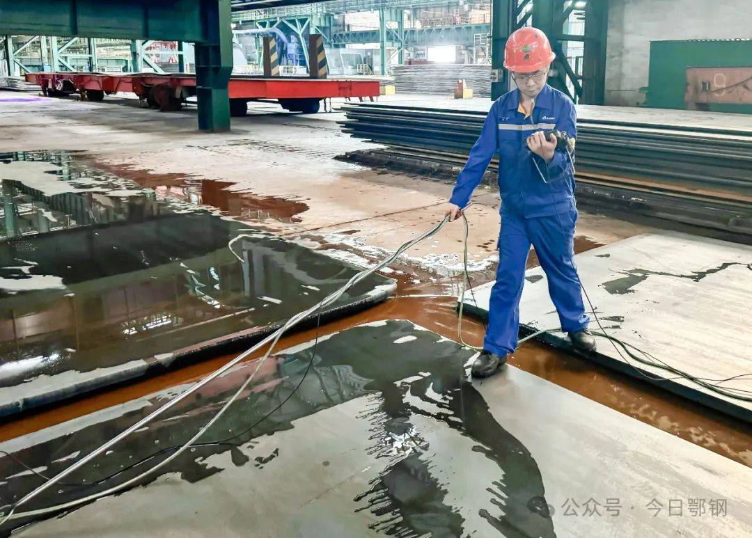 钢轧厂轧钢维检工正在对打包机进行巡检维修.