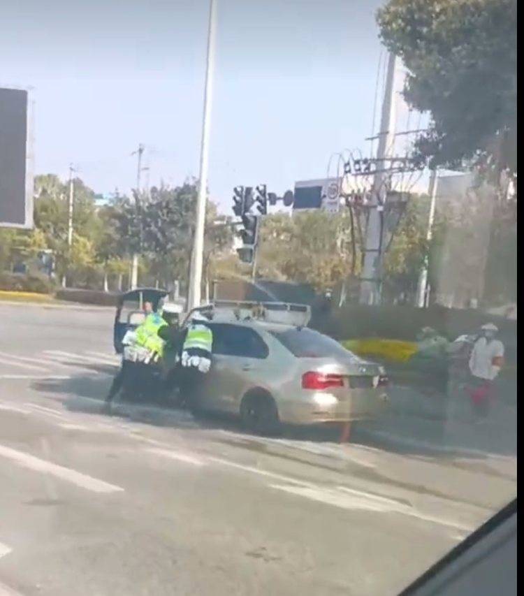 成都一车遮挡号牌冲卡带倒交警 警方：正查找涉事司机